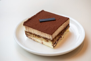 Square Tiramisu served on plate in the cafe