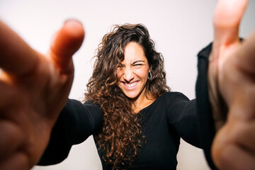 Excited young woman reaching out for a selfie