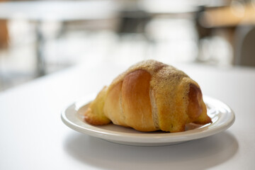 Salted bread with sweet sauce on the top, served on plate on the table