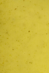 A creamy, vibrant yellow sauce, soup, or curry, such as a rich cheese sauce or flavorful Indian kadhi, fills the frame in a close-up, top-down view.