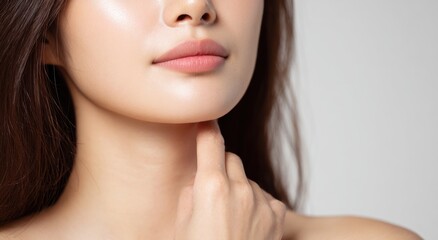 Fototapeta premium Close up of woman's face neck and hand touching skin