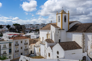 Scenic view of a church and traditional buildings in the Algarve region