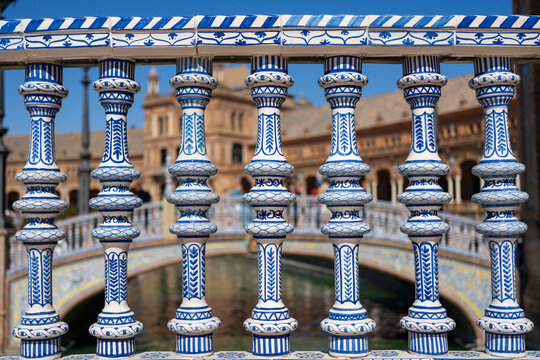 Decorative blue and white balustrade in Seville, Spain, with ornate architectural details