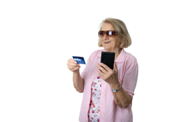 Senior woman doing online shopping holding smartphone and credit card