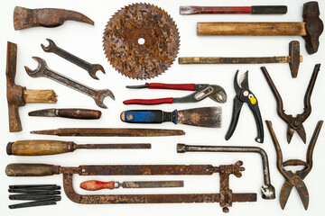 Flat lay of old hand tools on white background. Large collection of various rusty tools and bits arranged on white.
