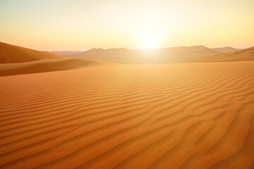 Endless horizons unfold in the panoramic vista of Oman's Empty Quarter, the Rub' al-Khali desert. Vast and serene, the landscape boasts undulating dunes that stretch into the distance