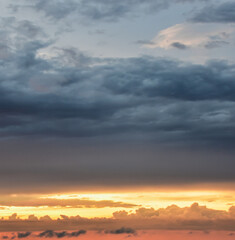 Dreamy evening horizon painted with delicate clouds and fading sunlight