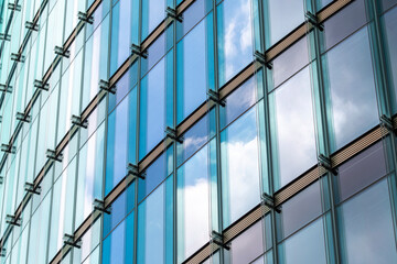 Architecture facade showing pattern and repetition with geometry, glass, reflection, structure, symmetry and abstract pattern forming an ordered and balanced visual composition