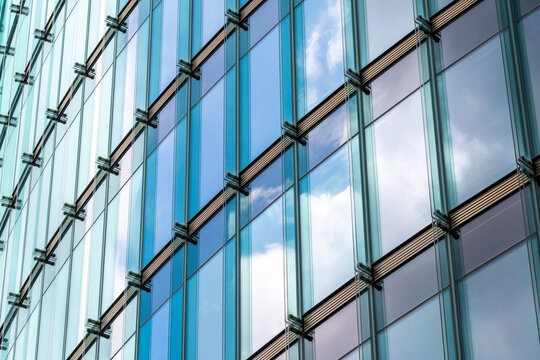 Architecture facade showing pattern and repetition with geometry, glass, reflection, structure, symmetry and abstract pattern forming an ordered and balanced visual composition