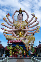 Large statue of Guanyin with multiple arms at Wat Plai Laem temple in Thailand