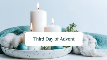 A serene and festive arrangement featuring two lit candles symbolizing the third day of advent nestled amongst soft cotton teal fabric and festive ornaments evoking a sense of anticipation and holiday