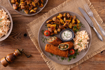 Pork chop rolls stuffed with spinach and mozzarella. Served with sun-dried tomatoes and roasted potatoes.