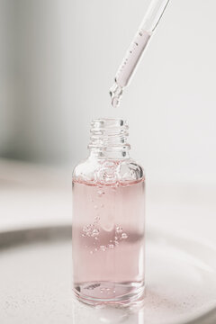 Pink Serum Dropper Bottle With Pipette.Demonstrating trendy color of the year 2026