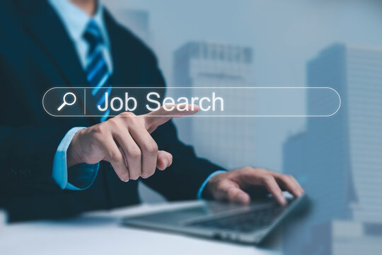 A business professional using a laptop and selecting a glowing job search bar, representing online recruitment, career searching, employment opportunities, and modern digital hiring processes.
