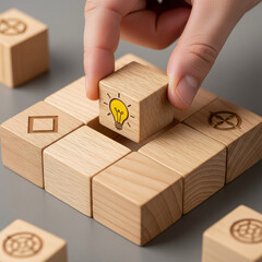 Hand Placing Idea Lightbulb Wooden Block in Puzzle Grid