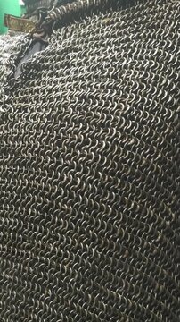 A close-up shot of a chain mail bag with intricate links and metal details