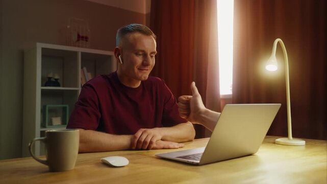 Business man see thump up remotely, thumbup like ok from laptop screen. Approval at home. Male employee virtual meeting. Successful distant interview. Guy good job video call. Work deal conference.
