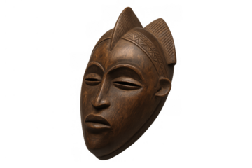 African tribal mask made of intricately carved dark wood, symbolizing tradition and ritual, isolated with a transparent background