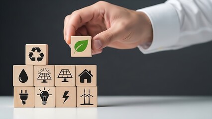Eco-friendly concept with hand arranging wooden blocks with green energy icons