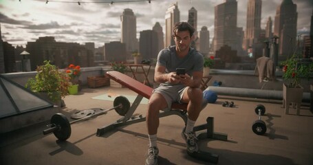 Athletic Young Man Exercises on Rooftop Gym, Using Smartphone Fitness App, Share Training Content on Social Media, Monitor Heart Rate, Health Care Performance Data  - Powered by Adobe