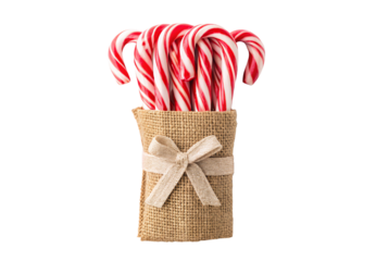 Red and white peppermint candy canes in burlap holder with bow, isolated on a transparent background