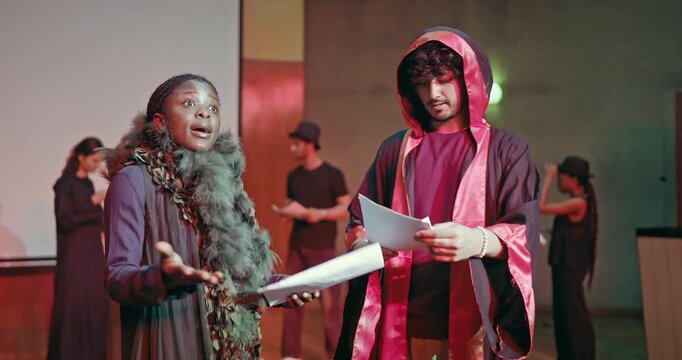 Indian young adult gen z lady female male man wear stage dress hold paper do casual scene studio hall happy boy girl read talk speak new story lines learn next drama play enjoy day time campus place - Powered by Adobe