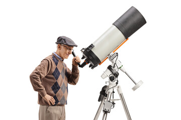 Fototapeta premium Elderly man observing the sky with a telescope