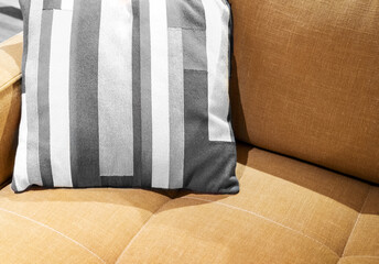 Multicolored pillow on yellow sofa background. New trending colour of the 2026 year 