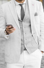 Portrait of stylish handsome young man with bristle standing outdoors
