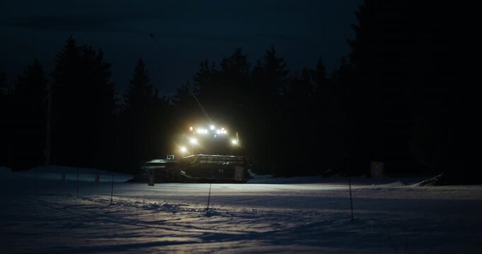 Snowcat Grooming Ski Slope at Night in Kopaonik, Serbia