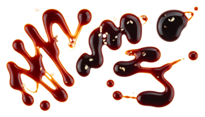 An artistic arrangement of rich brown soy sauce drops and abstract splashes sprinkled with sesame seeds