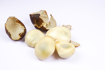 Salak fruit peeled and whole on white background