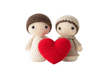 Two crocheted figurines embracing red heart, cute handmade love decoration, isolated on a transparent background