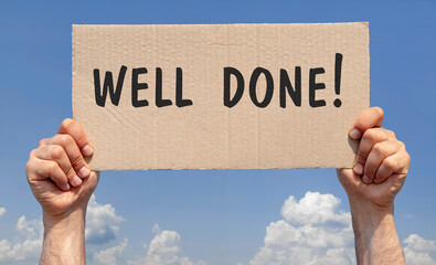 Hands holding a piece of cardboard with the inscription "Well done"