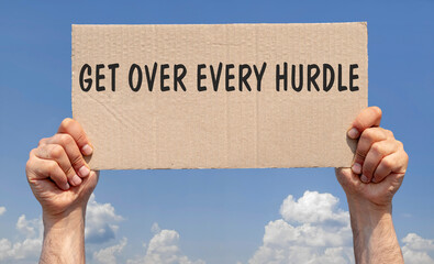 Hands holding a piece of cardboard with the inscription "Get over every hurdle"