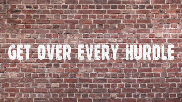 Inscription «get over every hurdle» on old brickwork