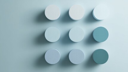 Minimalist geometric design with nine circular discs in gradient blue tones, Brain Teaser Month