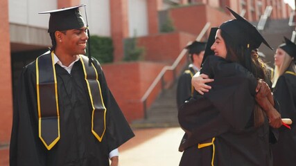 Happy graduates hugging and celebrating graduation day together - Powered by Adobe