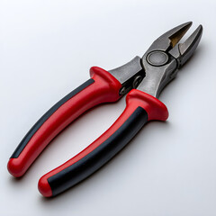 Close up of a pair of red and black handled combination pliers isolated on white background