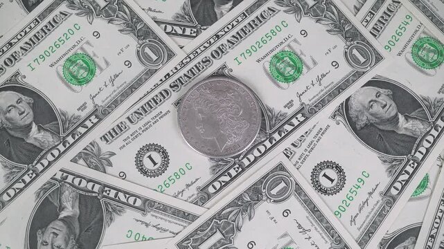 Close-up of Silver Coin Among Dollars.