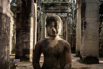 Ancient Buddha statue in the temple of Angkor Wat, Cambodia, with detailed carvings