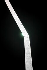 Reflective Road Marking Illuminated Against Black Background