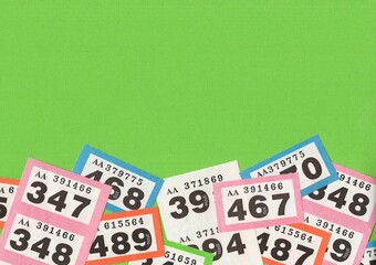 A montage of vintage raffle tickets on a bright green background with space for copy or text.