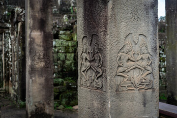 Ancient carvings of apsara dancers on pillars at Angkor Wat temple