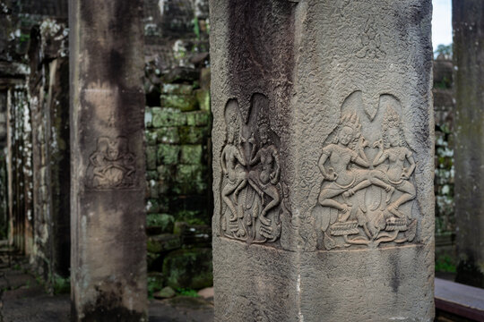 Ancient carvings of apsara dancers on pillars at Angkor Wat temple