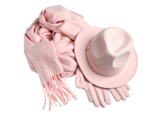 Pink hat, scarf, and gloves, artfully arranged against a dark backdrop, conveying warmth and style