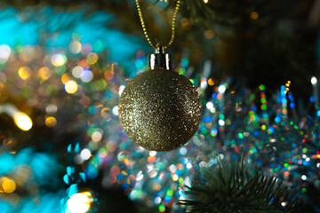 Golden Christmas Ornament with Glitter and Bokeh Lights