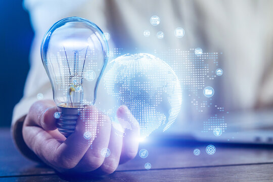 Innovative thinking with a light bulb and digital globe during a brainstorming session in a modern workspace