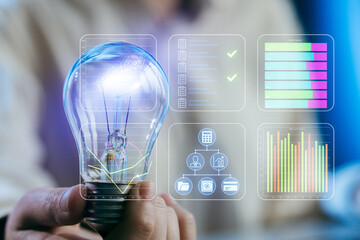 Creative light bulb with digital data overlay representing innovation and smart technology in a modern workspace