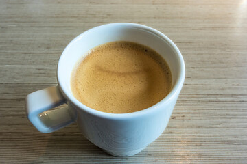 Espresso cup on wooden table enjoying coffee break